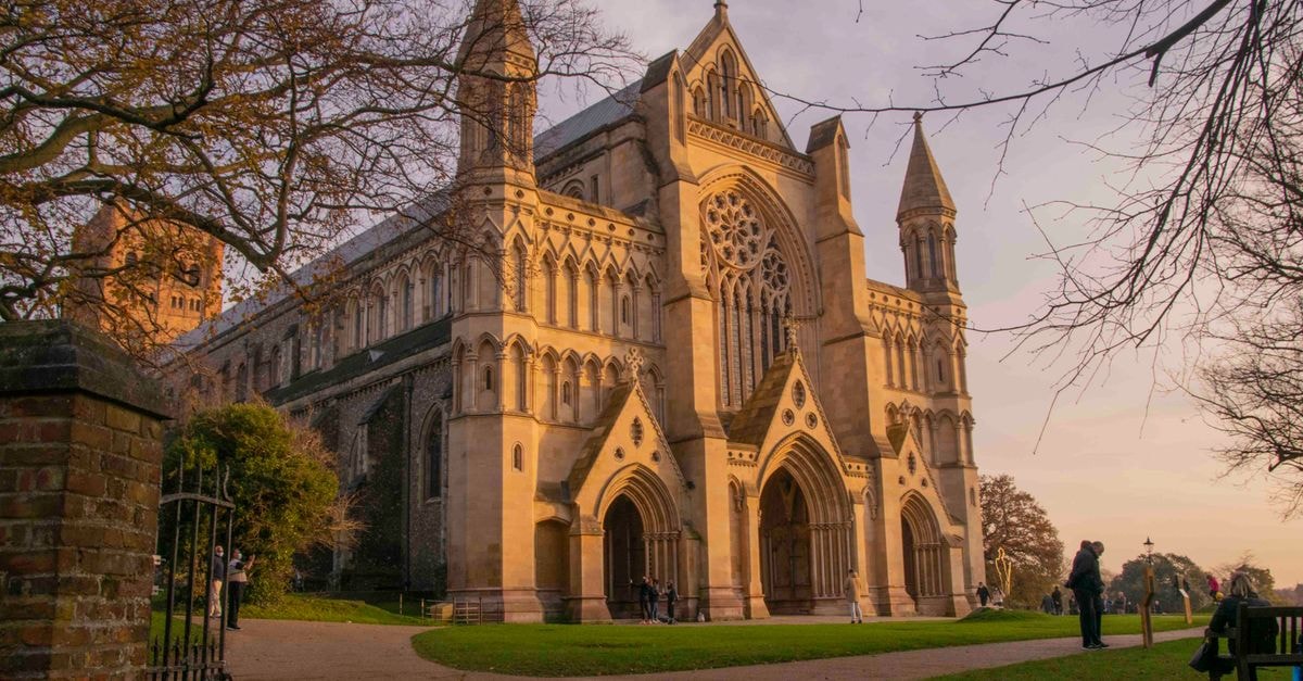 Norwich travel guide: an easy car-free city break The historic St Albans Cathedral lit by the warm glow of a sunset in England.