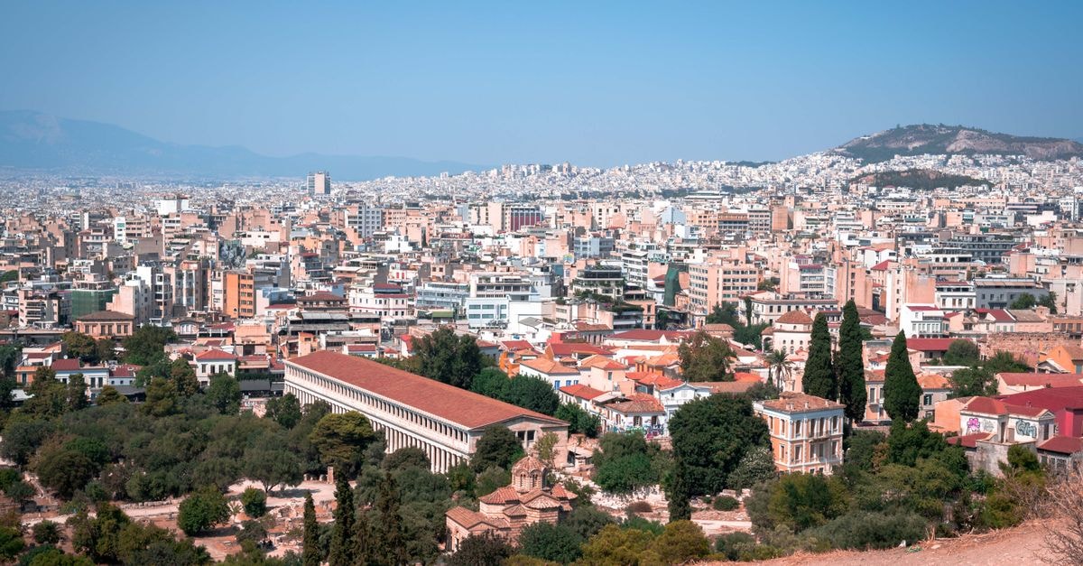 King George Hotel, Athens — A 19th-Century Palace Annex Turned Luxury Stay A breathtaking aerial view of Athens cityscape showcasing ancient landmarks and modern architecture.