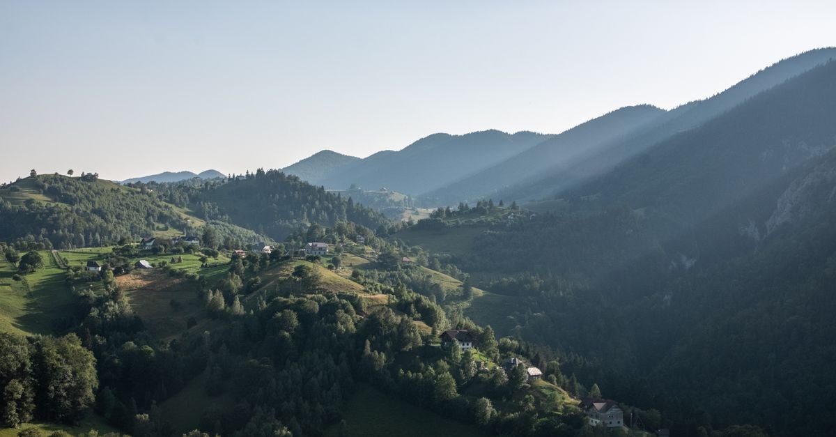Strumica Travel Guide: Festivals, Valleys and Slow Days Beautiful landscape of Măgura Village with lush hills and sunlit mountains in Brașov, Romania.