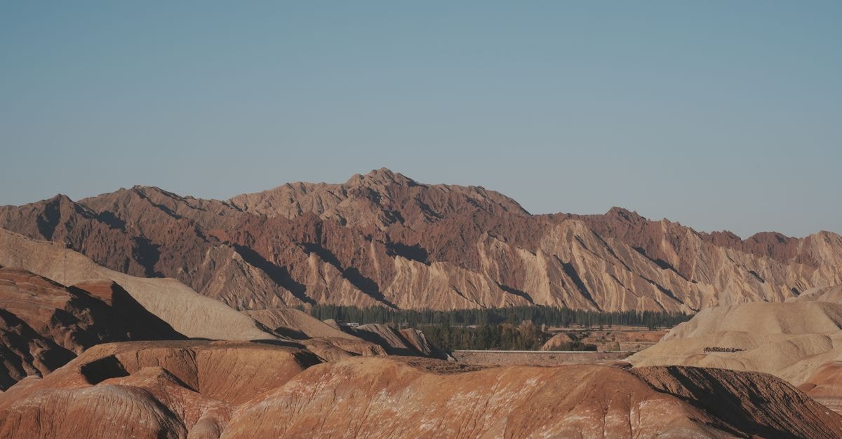 Turpan Travel Guide: Planning Tips, Costs and Things to Do Breathtaking view of a desert mountain landscape under a clear blue sky, showcasing beautiful earth tones.