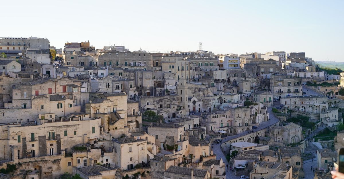 ALMA CAMERE MATERA in Matera: A Quiet Guest House Near the Sassi A serene view of the ancient stone cityscape of Matera, showcasing historic architecture under the clear sky.