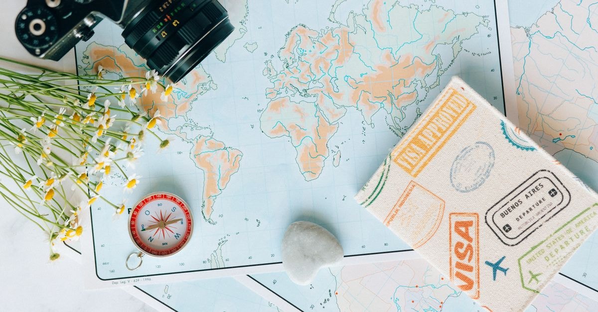 Sapele Travel Guide: Planning Tips, Costs and Things to Do Flat lay of travel essentials: maps, camera, compass, and travel journal for planning adventures.