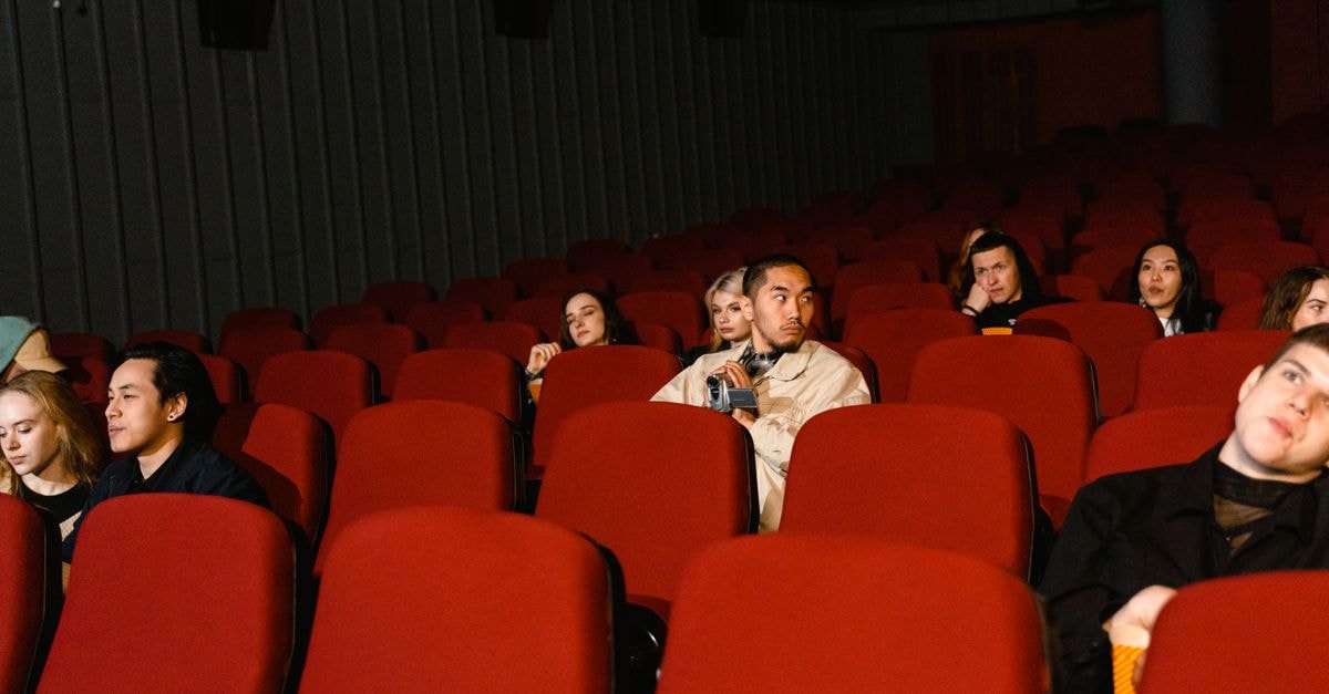 'Resident Evil' opens to $108.3M worldwide as 'Coyote vs. Acme' crosses $100M globally Group of people watching a film in a sparsely populated cinema theater.