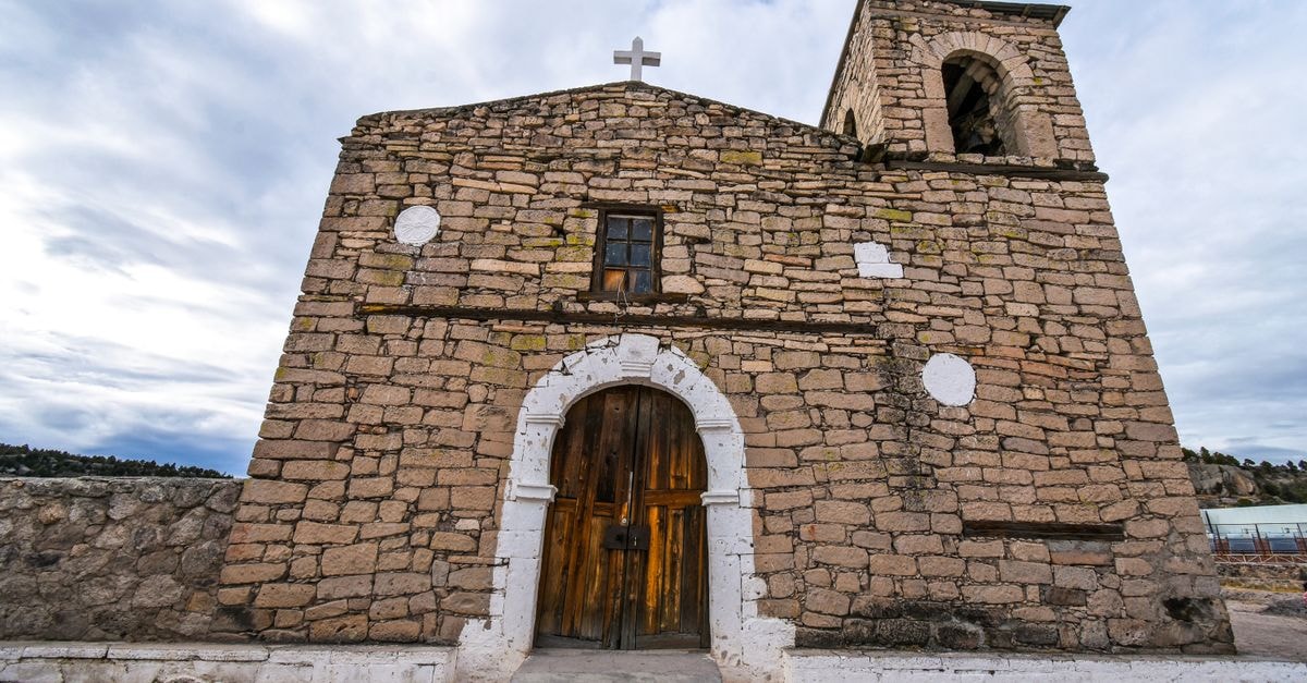 Front view of a historic stone church in Aquibachi, Mexico. Iconic architecture with a rustic facade.