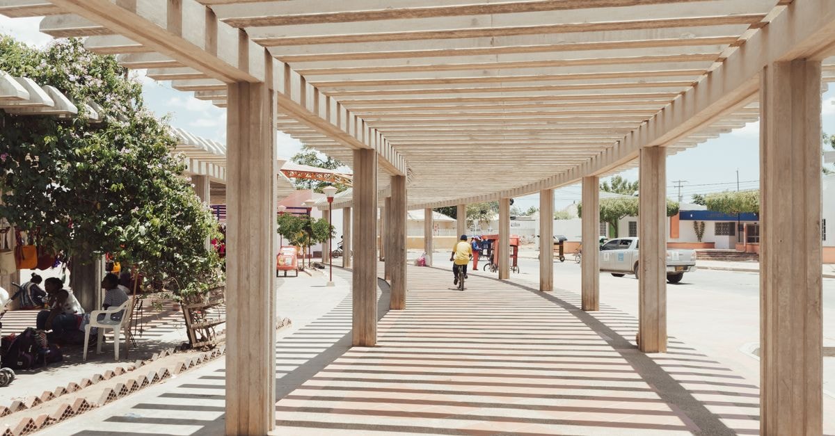 Formosa Travel Guide: Getting Around and Eating Well 's Chaco Capital A bright urban walkway casting intricate shadows with people in the background, exuding a lively atmosphere.
