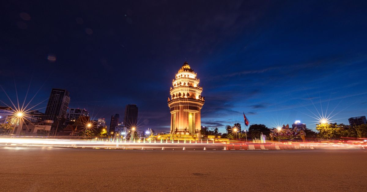 Stunning nighttime view of an illuminated city monument surrounded by city lights.