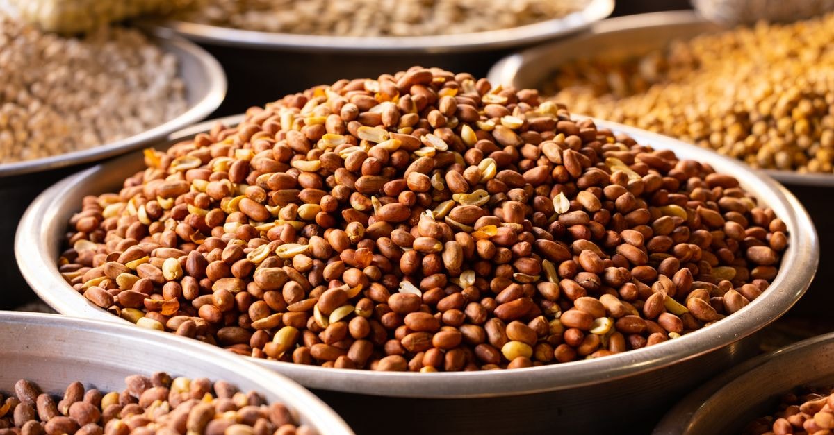 Diourbel Travel Guide: Peanut Markets, Sacred Neighbors, and Slow Senegal Close-up of roasted nuts in stainless bowls at a market, showcasing a variety of healthy and nutritious snacks.