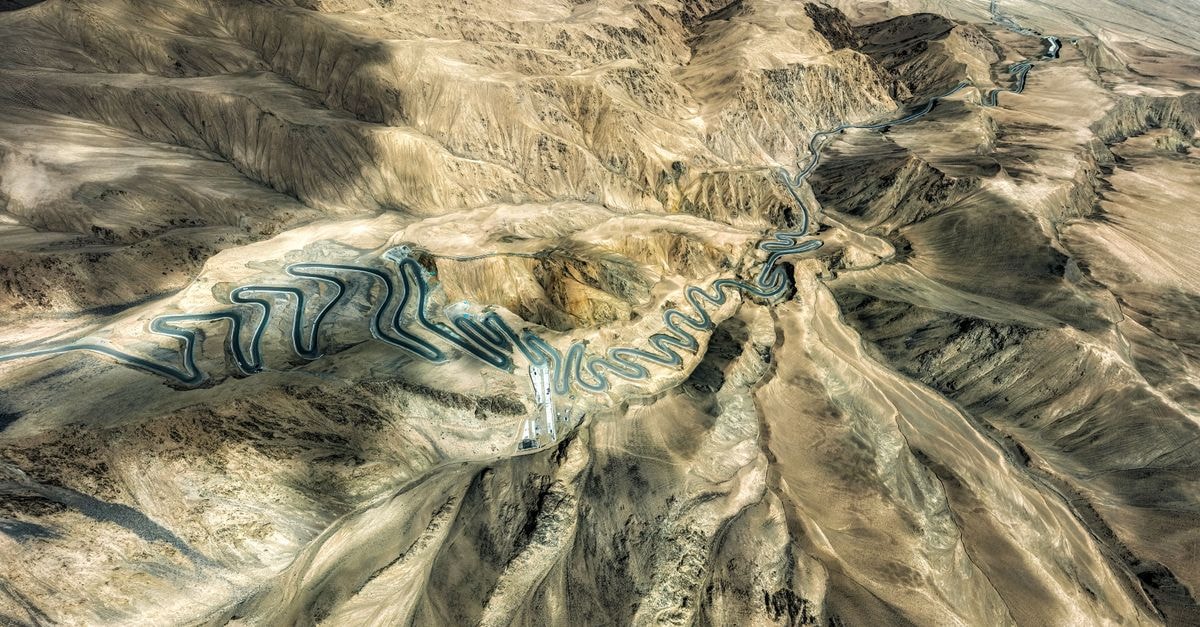 Sultan Hotel, Kashgar — A Century-Old Stay Steps from the Old City A breathtaking aerial view of a winding road in the rugged terrain of Kashgar Prefecture.