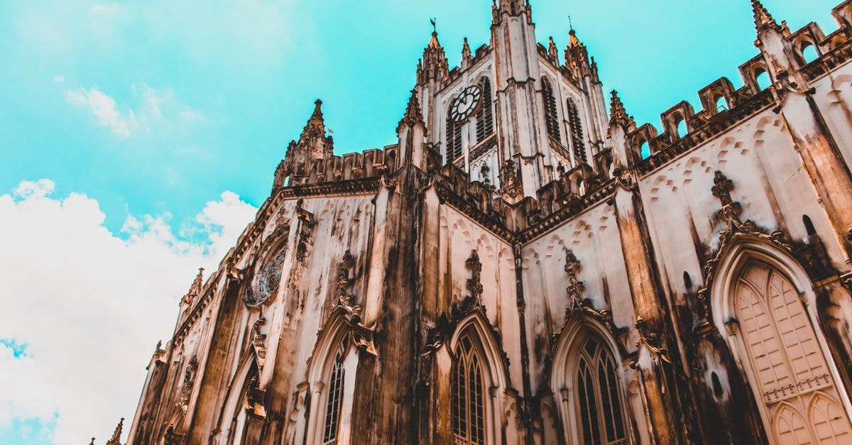 Maheshtala Travel Guide: Quiet Kolkata-Adjacent Stays Low-angle shot of St. Paul's Cathedral, showcasing its Gothic architecture against a blue sky.