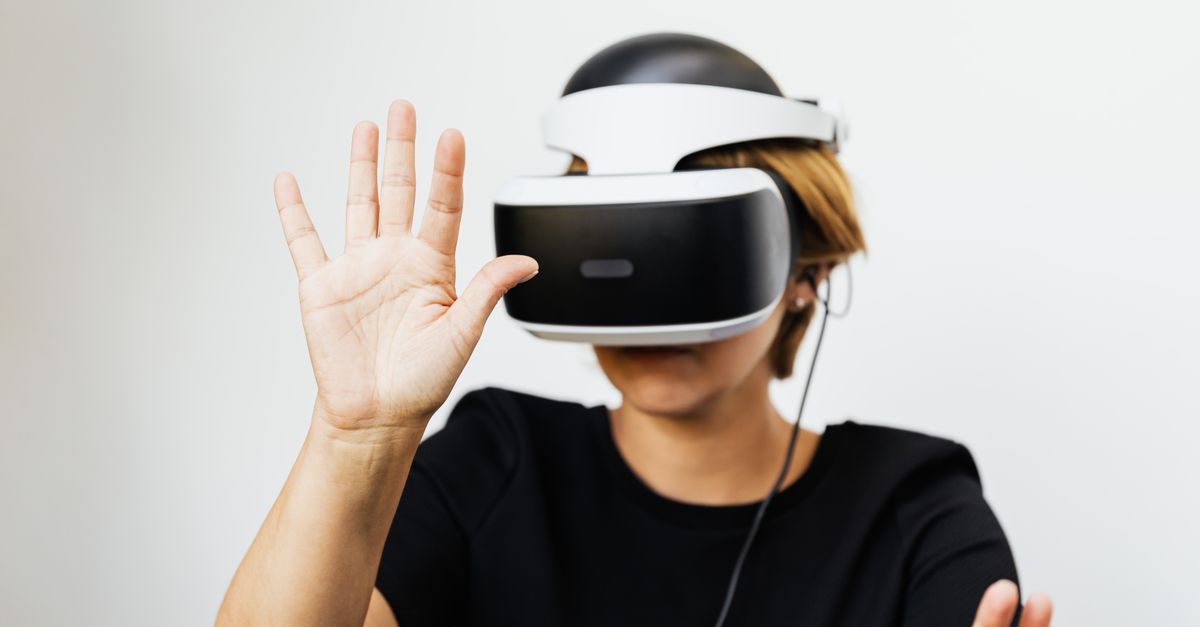 Kmart launches $89 Anko smart glasses in Australia as Apple doubles down on privacy for its wearables push Woman experiencing virtual reality with VR headset on white background.
