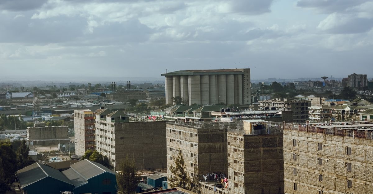 Chambai Hotel in Narok: A Quiet Stop Near the Mausa Police Station and the Narok Museum Aerial view of an urban cityscape featuring high-rise buildings and an industrial area under a cloudy sky.