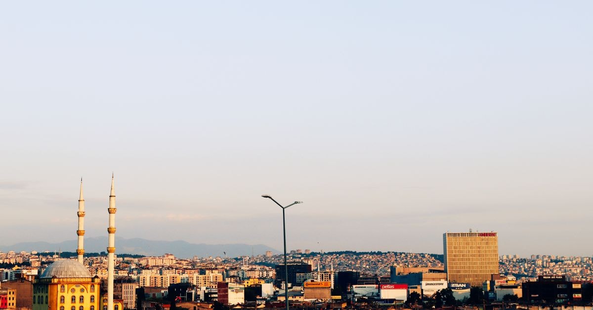 Sheraton Grand Samsun Hotel in Samsun: Black Sea Views on Atatürk Bulvarı Expansive cityscape of Samsun, Türkiye, featuring a mosque and urban skyline at sunset.