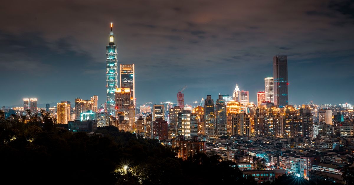 Howard Johnson Formosa: A Modern Hotel Casino on Avenida Gobernador Gutnisky Panoramic view of Taipei City skyline featuring the illuminated Taipei 101 tower.