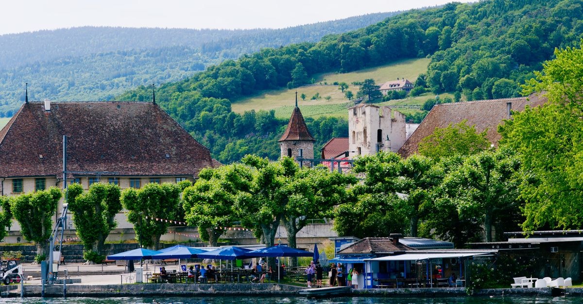 Scenic view of historic buildings along the Doubs River in Saint-Ursanne, Switzerland.