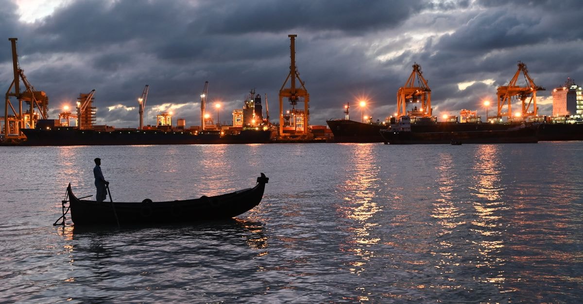 Tower Inn in Chittagong: A Jubilee Road Stay Near the Court Building A fisherman on a boat during twilight at the industrial Chittagong port, Bangladesh.