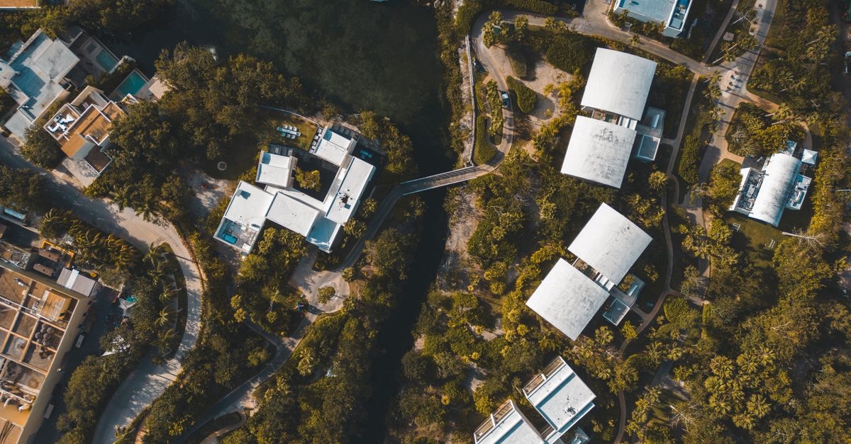 Colonial Playa del Cármen in Playa del Carmen: A 20 Avenida Norte Address Aerial shot of a tropical residential area in Playa del Carmen, Mexico, showcasing lush greenery and modern architecture.