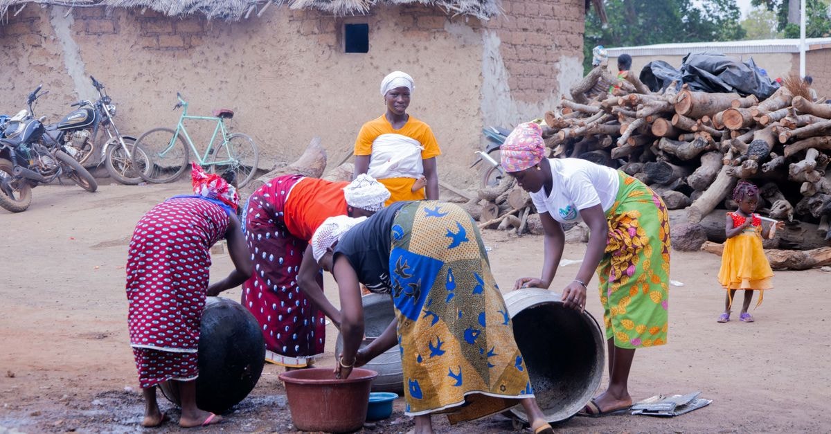 Daloa, Ivory Coast Travel Guide: Cocoa Crossroads African women engaged in community work in a rural village setting in Korhogo, Côte d'Ivoire.