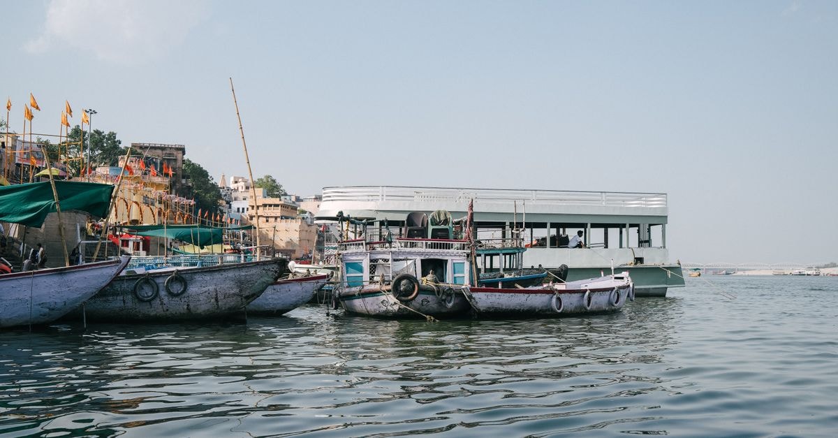 Hotel Ganges Grand, Varanasi — A Dashashwamedh Road Stay by the Ganges Traditional boats docked along the Ganges River in Varanasi, capturing the essence of Indian river life.