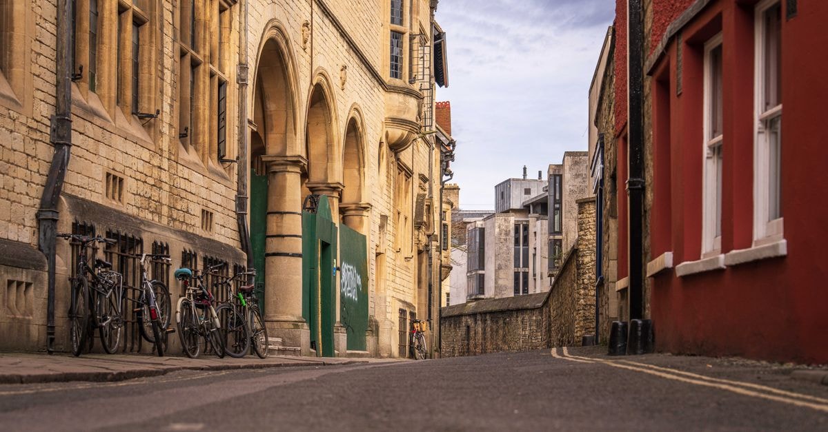 The Jericho Hotel, Oxford — A Family-Friendly Base Near the Old Colleges A picturesque cobblestone street in an old town with bicycles lined up against historical buildings.