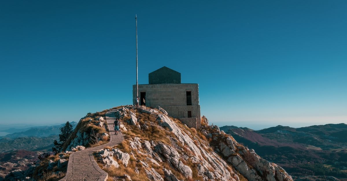 Pedra Badejo Travel Guide: Planning Tips, Costs and Things to Do Scenic view of the mausoleum at Mount Lovćen in Montenegro, perfect for hiking enthusiasts.