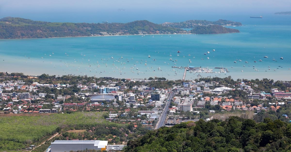 Port Moresby Travel Guide: Birds, Sweet Potatoes and the Sea A stunning aerial view of Karon Beach, Phuket, featuring turquoise waters and urban landscape.