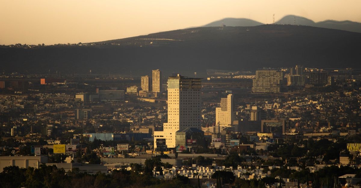 Explore the cityscape of Santiago de Querétaro, Mexico with its impressive buildings illuminated by the sunset glow.