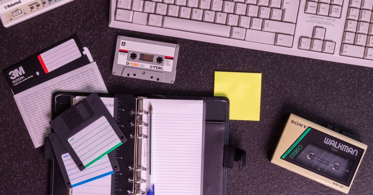Bambari Travel Guide: History, Community, and Climate Notes A nostalgic setup with vintage electronics like a Walkman, floppy disks, and a typewriter keyboard.