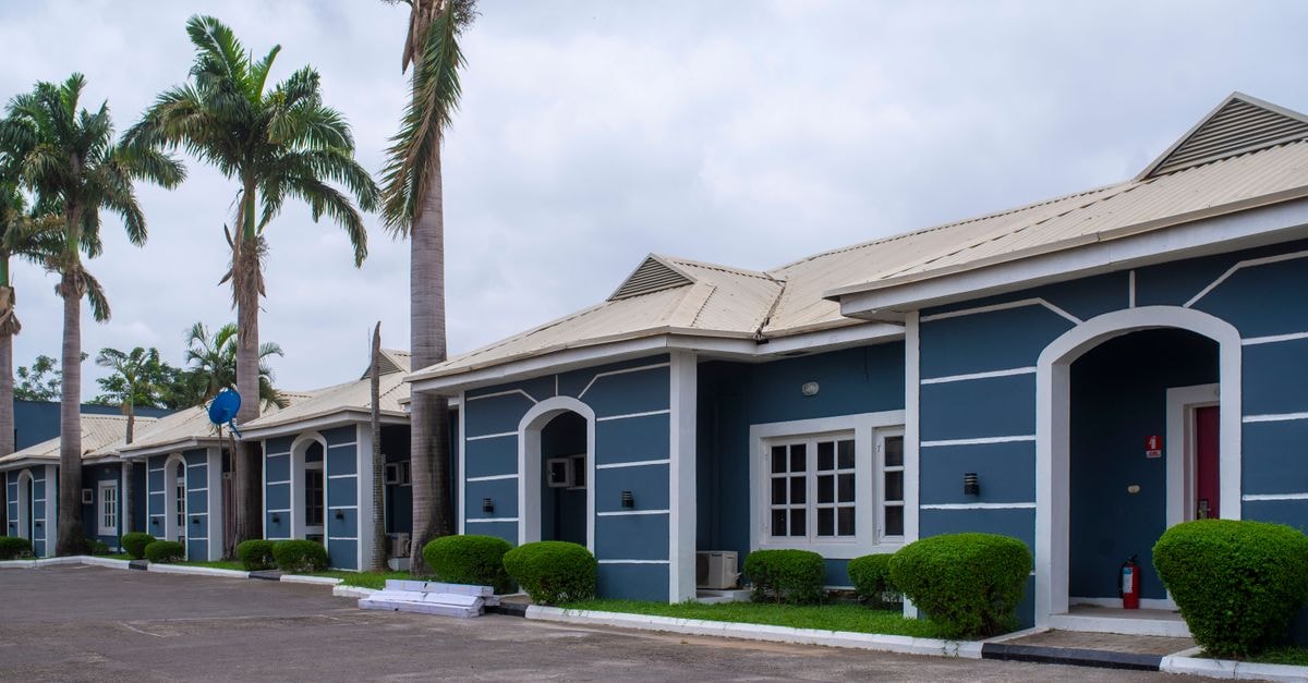 Ado-Ekiti Travel Guide: Things to Do in Nigeria's Quiet Capital Stylish tropical apartments with palm trees in Abuja, Nigeria, showcasing modern architecture.