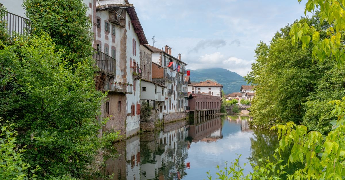 Slow Days in Maevatanana: A Quiet River Town Travel Guide Picturesque view of traditional buildings by a river in Elizondo, Spain.