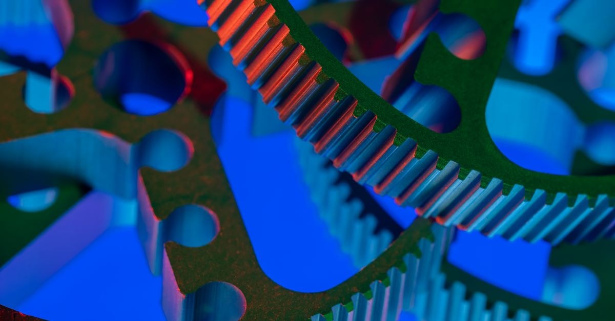 Vibrant close-up view of interlocking industrial gears, showcasing precision engineering.
