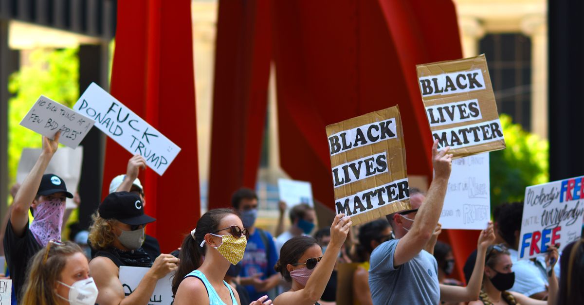 "The Daily Show" Targets Trump Over Georgia Rally Energy and World Cup Stage Moment Protesters gather with signs supporting Black Lives Matter and denouncing Donald Trump in a peaceful rally.