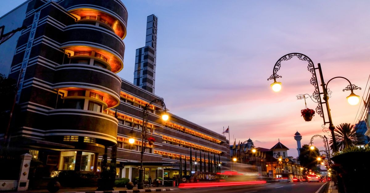 Hotel Golden Flower, Bandung: 194 Rooms on Jalan Asia Afrika A stunning view of Art Deco architecture in Bandung, Indonesia during a vibrant sunset.