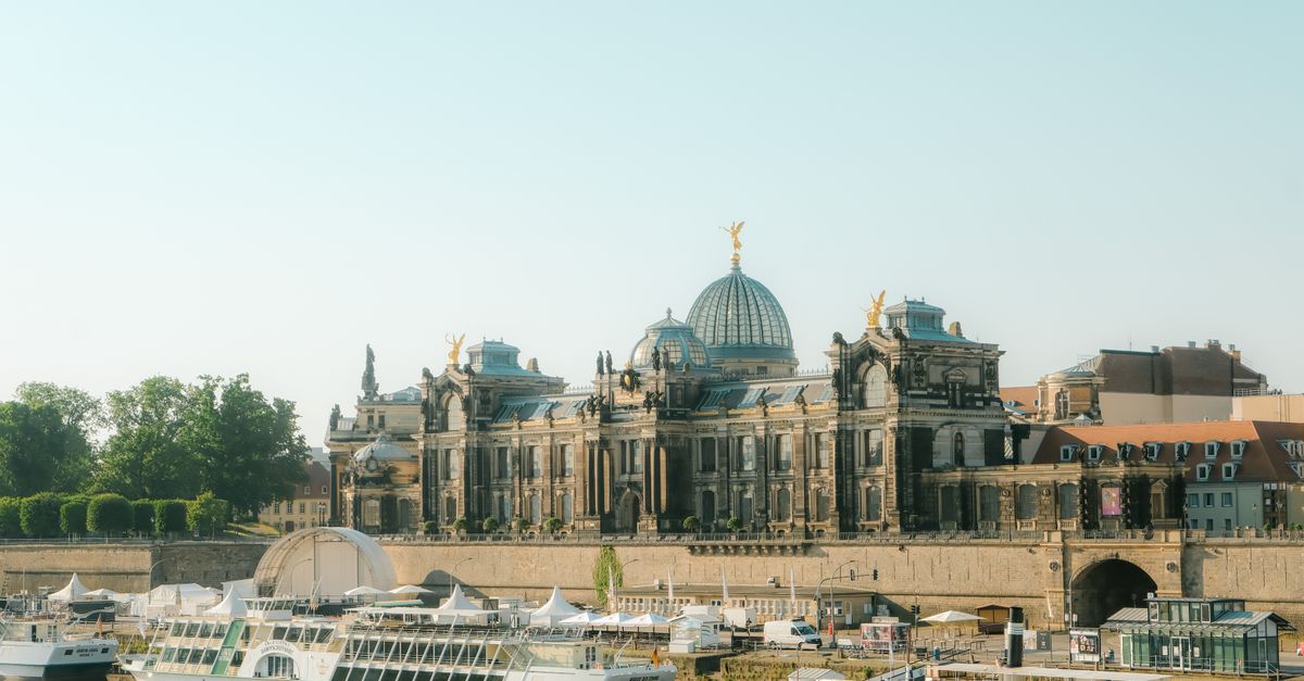 Things to Do in Dresden in July 2026: A Practical Travel Guide View of the Academy of Fine Arts Dresden with boats on the Elbe River under a clear sky.