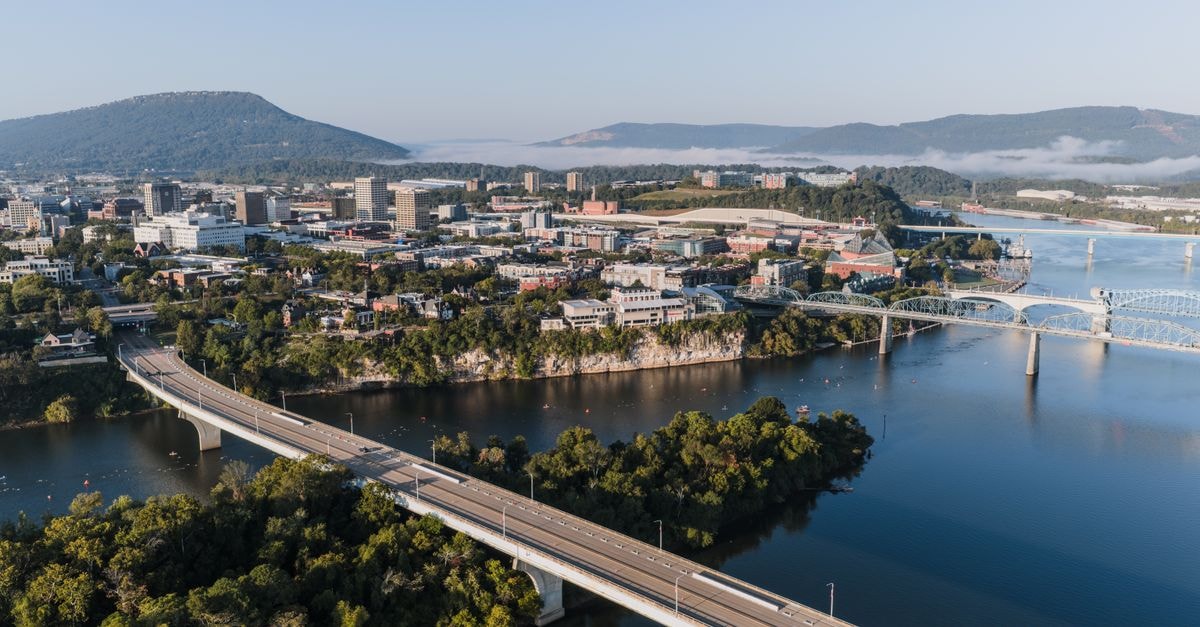 Stunning aerial view of Chattanooga's skyline with bridges and mountains in the background.