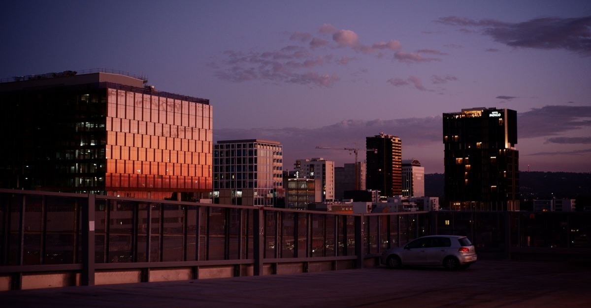 Beautiful twilight view of Adelaide's skyline with modern buildings reflecting sunset hues.