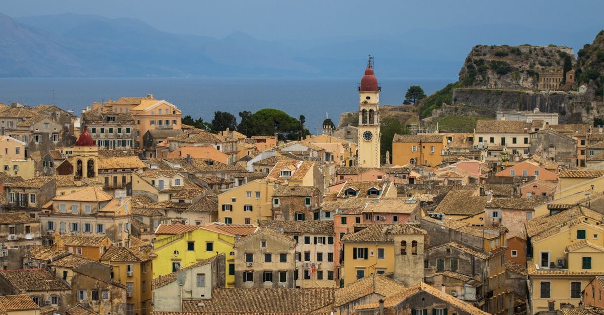 A Slow Travel Guide to Corfu: Old Town Charm, Island Buses, and Easy Days Stunning aerial panorama showcasing the charming architecture of Corfu Old Town, Greece.