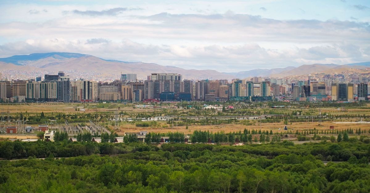 Panoramic view of Ulaanbaatar with greenery and mountains in Mongolia.