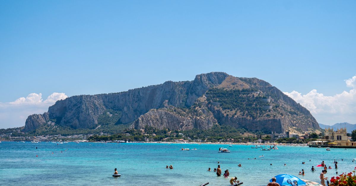 Enjoy a sunny day at Mondello Beach with stunning views of Mount Pellegrino in the background.