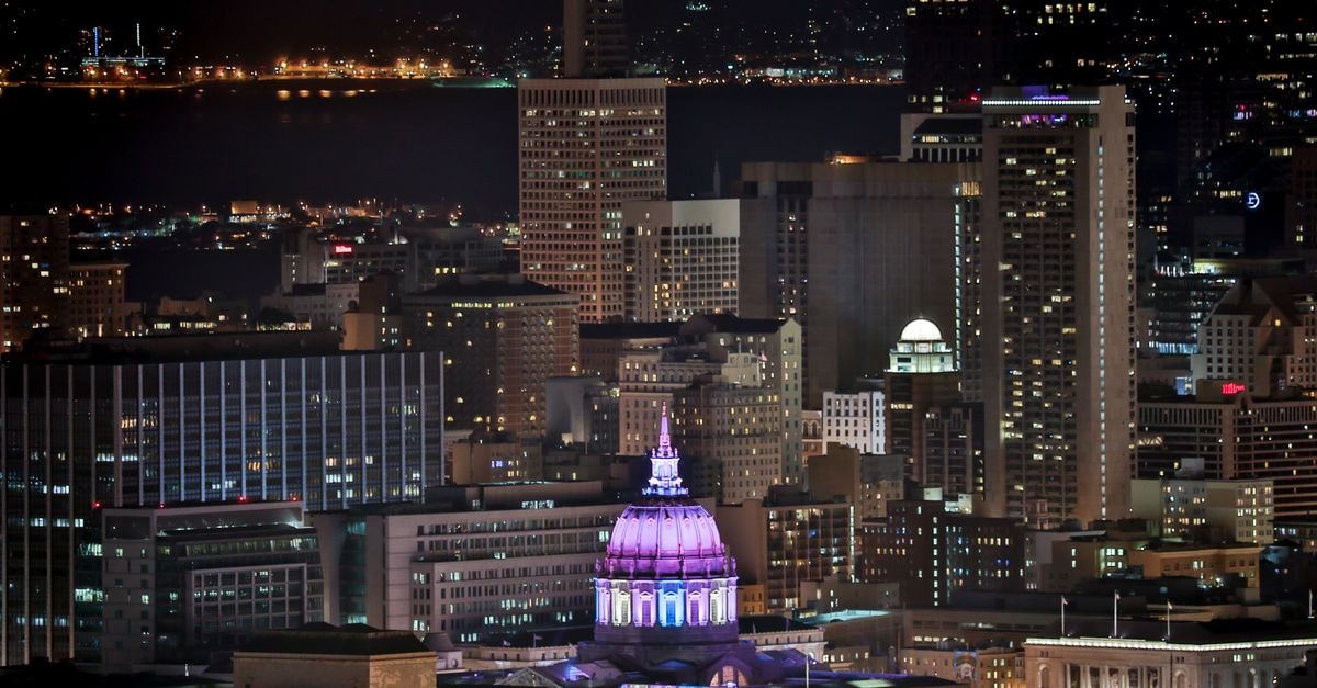 YOTEL San Francisco: Cable Cars at Your Door on Market Street A stunning view of San Francisco skyline at night, featuring a brightly lit dome.