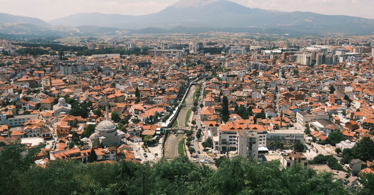 Elbasan Travel Guide: Planning Tips, Costs and Things to Do Explore the vibrant cityscape of Prizren with a stunning mountain backdrop.