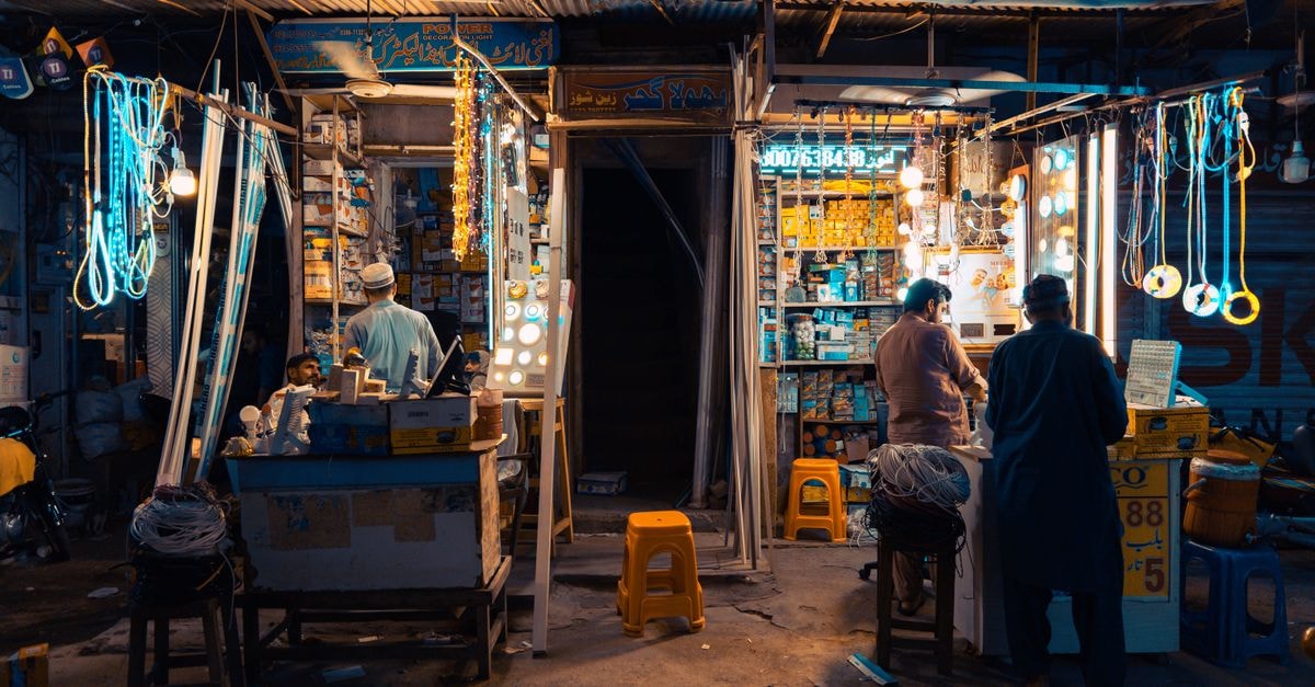 Rawalpindi Travel Guide: Markets, Bazaars, and City Rhythm Colorful street market in Faisalabad at night, showcasing local vendors and vibrant lights.