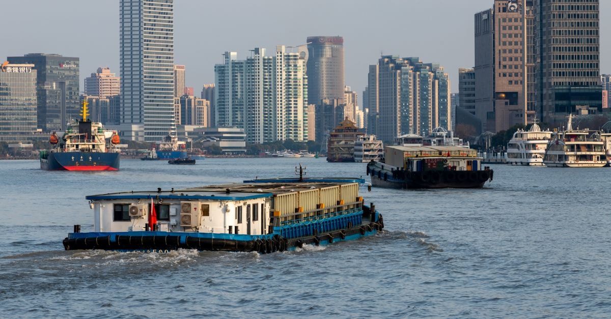 A Quiet Yangtze Riverside City: Ma'anshan Travel Guide Barges navigate the Huangpu River against the stunning backdrop of Shanghai's modern skyscrapers.