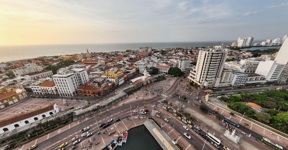 A breathtaking aerial view capturing Cartagena's vibrant streets, historic architecture, and stunning waterfront at sunset.
