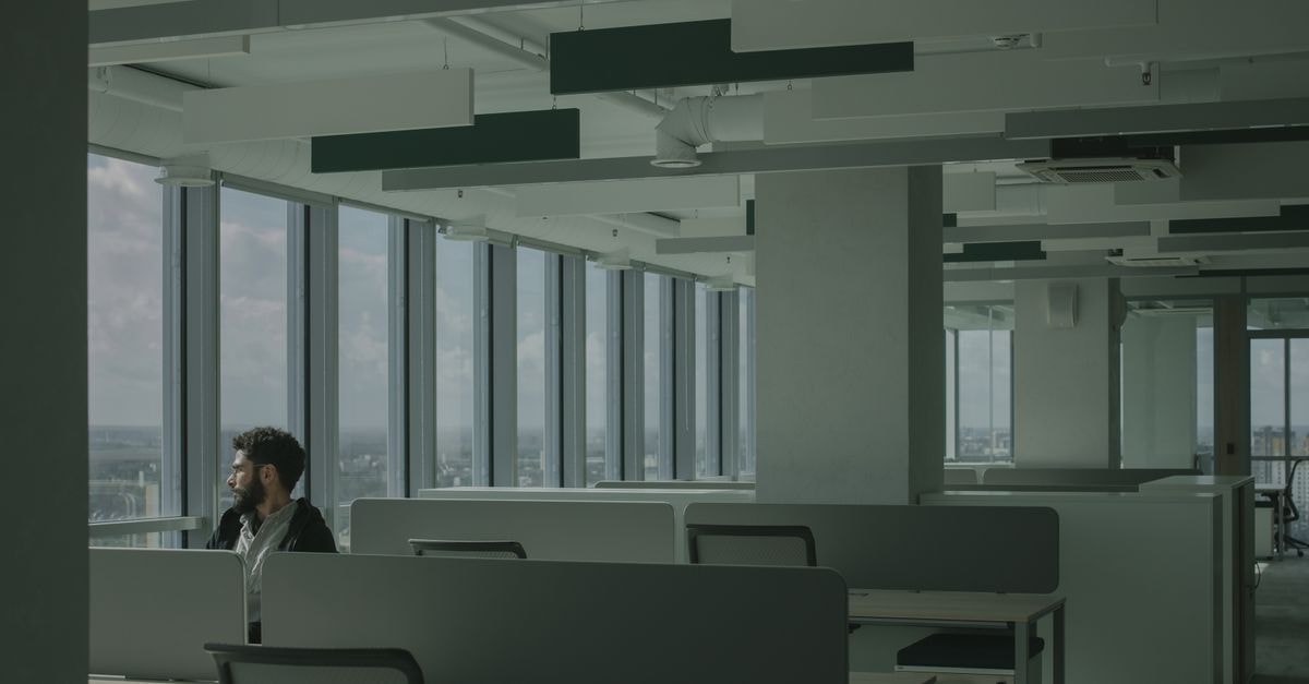 Orlando Starbucks workers join nationwide boycott push for first union contract A man sits alone in a modern office space with large windows overlooking a cityscape.
