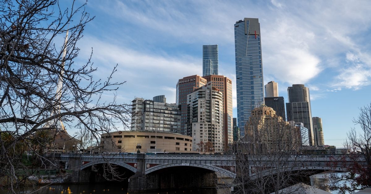 Hilton Melbourne Little Queen Street: Heritage Equity Chambers Stay View of Melbourne's skyline and Yarra River on a clear day, showcasing iconic architecture.