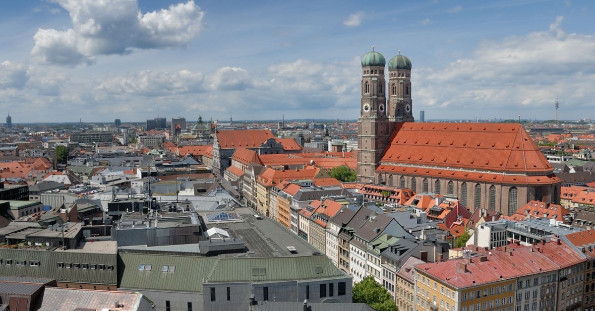 Beyond by Geisel in Munich: 19-Room Boutique Stay on Marienplatz Aerial view of Munich's urban landscape highlighting the iconic Frauenkirche.