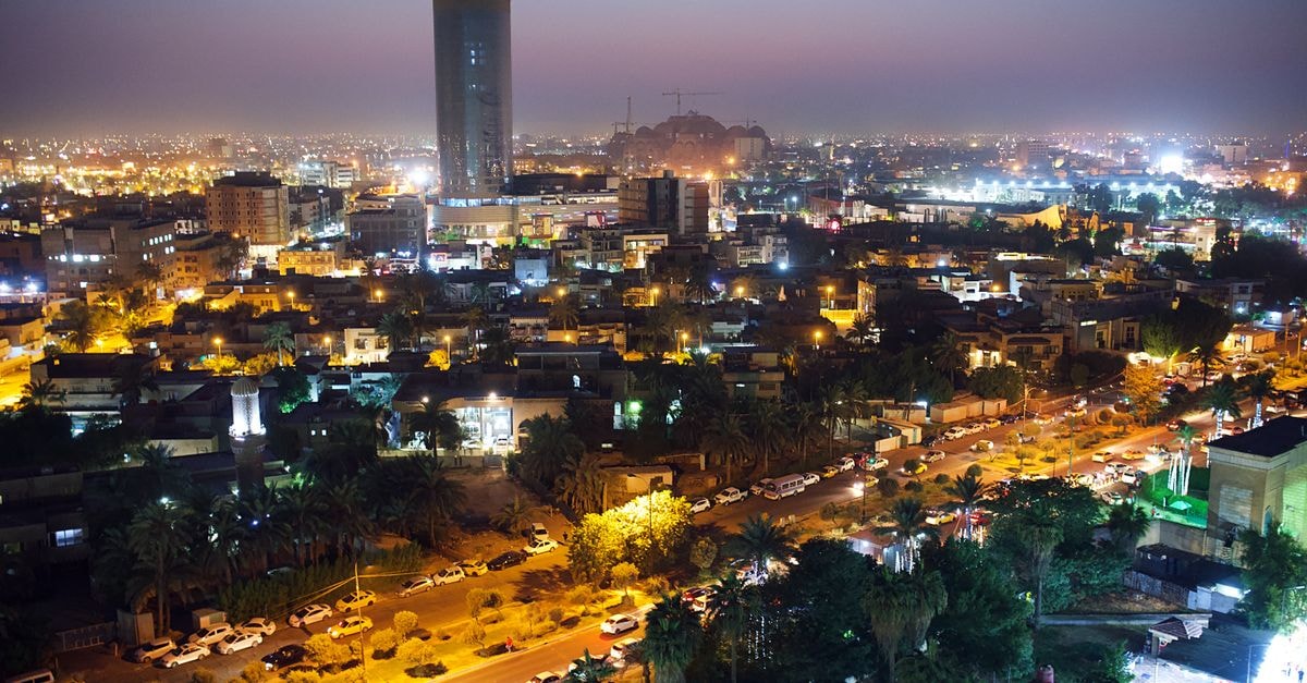 Elite Hotel Al Hamra, Jeddah — A Corniche Road Stay A breathtaking aerial view of Baghdad's skyline at night, showcasing illuminated buildings and bustling streets.