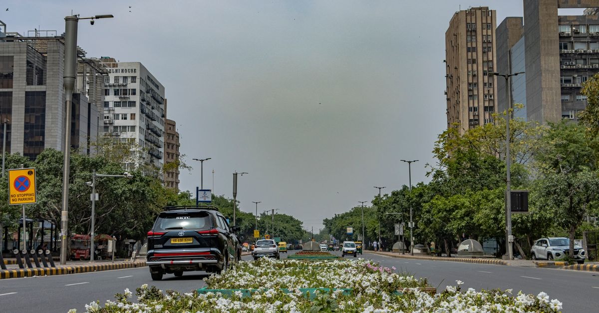 Zostel Delhi, New Delhi — A Backpacker Hostel in the Heart of the Capital Explore the urban architecture and vibrant street life of New Delhi, India, captured in a dynamic street scene.