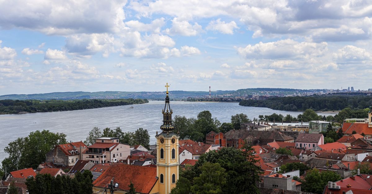 Castellum in Čakovec: A City-Centre Business Stay Near Varaždin Aerial view of Zemun's historic rooftops and the Danube River under a cloudy sky.