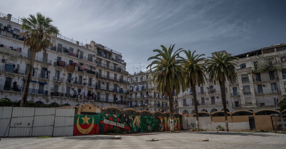 Hotel Soltane, Algiers — A Central Hussein Dey Base Near Amirouche Metro Historic Casbah of Algiers with palm trees and colorful murals under a cloudy sky.
